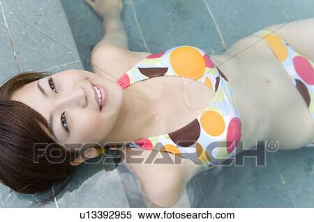 Young woman in a bikini sitting in swimming pool, Saipan View Large Photo Image Stock Photography - Young woman in a bikini sitting in swimming pool, Saipan. Fotosearch