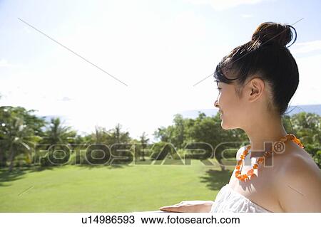 Stock Image - Young Woman looking at the view, Saipan. Fotosearch