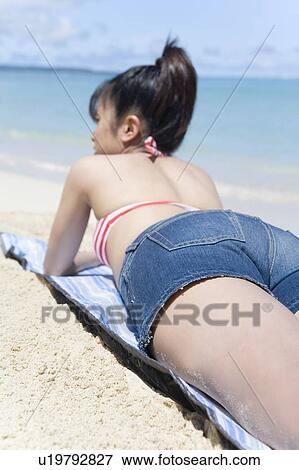 Young woman lying on beach, Saipan, USA View Large Photo Image Stock Photo - Young woman lying on beach, Saipan, USA . Fotosearch