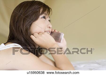 Young woman using a cell phone, Saipan View Large Photo Image Stock Photo - Young woman using a cell phone, Saipan. Fotosearch