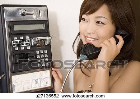 Young woman using a public phone, Saipan View Large Photo Image Stock Image - Young woman using a public phone, Saipan. Fotosearch