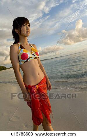 Young woman walking on beach, smiling, Saipan, USA View Large Photo Image Stock Image - Young woman walking on beach, smiling, Saipan, USA . Fotosearch