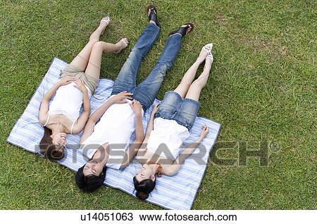 Young people smiling and lying on lawn, Saipan, USA View Large Photo Image Stock Image - Young people smiling and lying on lawn, Saipan, USA . Fotosearch