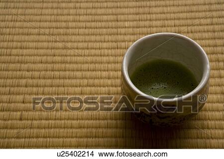 Picture - A cup of Japanese tea on Tatami mats, high angle view, close up, copy space, Japan. Fotosearch