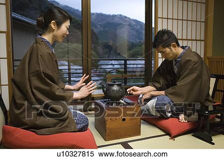 Japanese couple in Yukata sitting by the tea kettle in room, side view, Japan View Large Photo Image Stock Photography - Japanese couple in Yukata sitting by the tea kettle in room, side view, Japan. Fotosearch