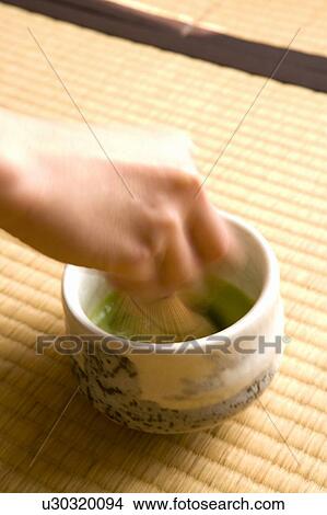 Person stirring Japanese tea with a tea whisk, high angle view, close up, blurred motion, Japan View Large Photo Image Picture - Person stirring Japanese tea with a tea whisk, high angle view, close up, blurred motion, Japan. Fotosearch