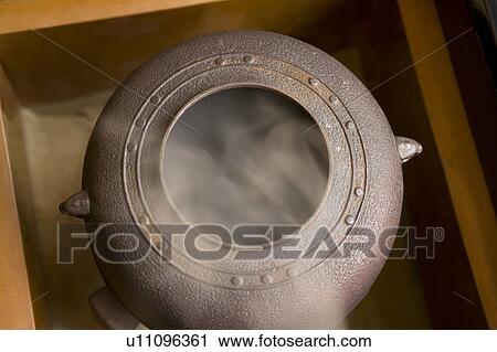 Stock Image - Steam coming out of a tea kettle, high angle view, close up, Japan. Fotosearch