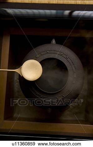 Stock Photo - Tea kettle and a bamboo dipper, high angle view, close up, Japan. Fotosearch