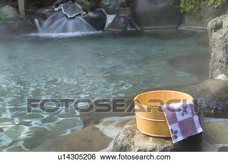 Stock Photograph - Towel on a wooden tub, hot spring, high angle view, Japan. Fotosearch