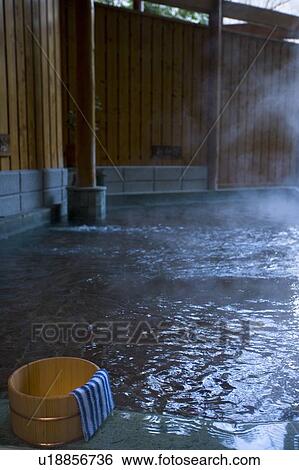 Stock Photograph - Towel on a wooden tub, hot spring, high angle view, Japan. Fotosearch