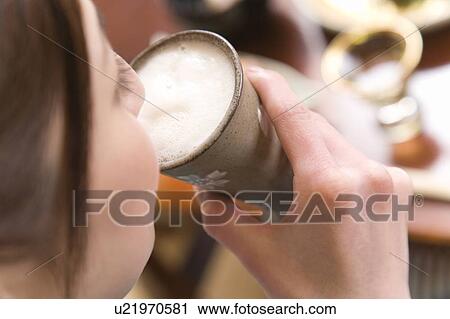 Stock Image - Woman drinking beer, high angle view, close up, Japan. Fotosearch