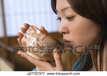 Woman drinking Japanese tea, side view, close up, Japan View Large Photo Image Stock Photo - Woman drinking Japanese tea, side view, close up, Japan. Fotosearch