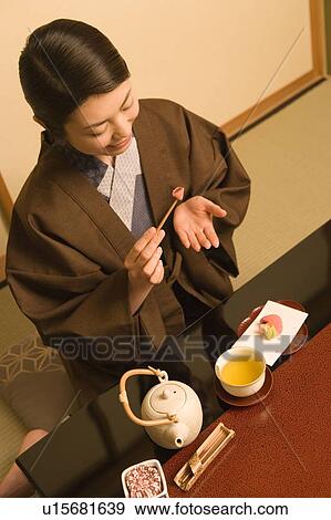 Woman in Yukata taking shi in room, high angle view, Japan View Large Photo Image Stock Photo - Woman in Yukata taking shi in room, high angle view, Japan. Fotosearch