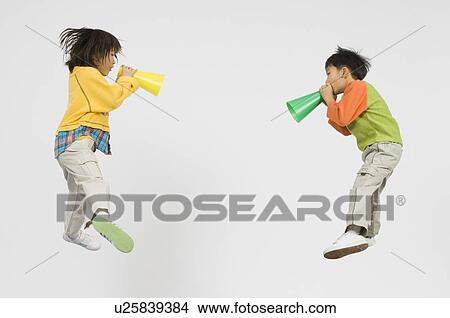 Picture - Boy and Girl holding megaphone. Fotosearch