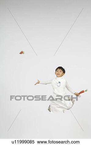 Stock Photography - Boy holding carrot. Fotosearch