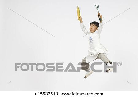 Stock Image - Boy holding corn. Fotosearch