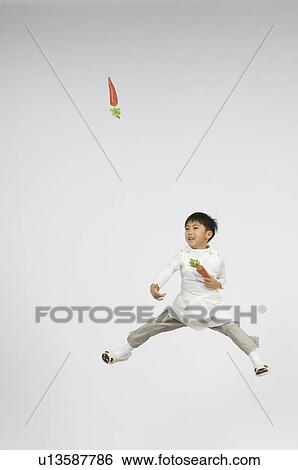Boy throwing carrot View Large Photo Image Stock Photograph - Boy throwing carrot. Fotosearch