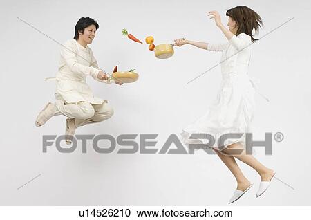 Couple holding flying pan View Large Photo Image Stock Image - Couple holding flying pan. Fotosearch