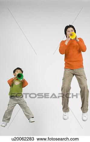 Stock Image - Father and son cheering with megaphone. Fotosearch
