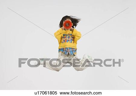 Stock Photography - Girl cheering with megaphone. Fotosearch