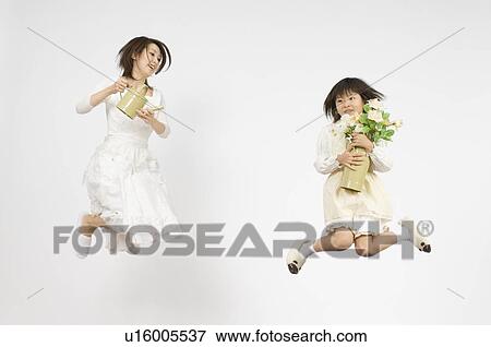 Girl holding flower and mother holding watering can View Large Photo Image Stock Photo - Girl holding flower and mother holding watering can. Fotosearch