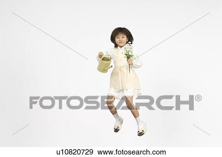 Stock Photo - Girl holding flower and watering pot. Fotosearch