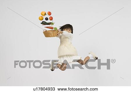 Girl holding vegetable in basket View Large Photo Image Stock Image - Girl holding vegetable in basket. Fotosearch