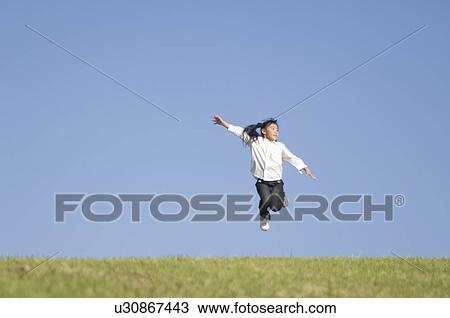 Girl jumping on grass View Large Photo Image Stock Image - Girl jumping on grass. Fotosearch