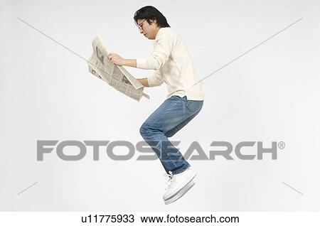 Stock Image - Man reading newspaper. Fotosearch