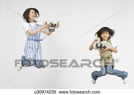 Stock Photography - Mother and Daughter cooking. Fotosearch