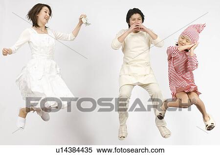 Stock Photography - Mother and Father waking up their daughter. Fotosearch