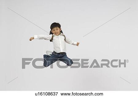 Stock Photo - Schoolboy jumping. Fotosearch