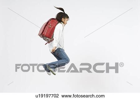 Stock Image - Schoolgirl jumping. Fotosearch
