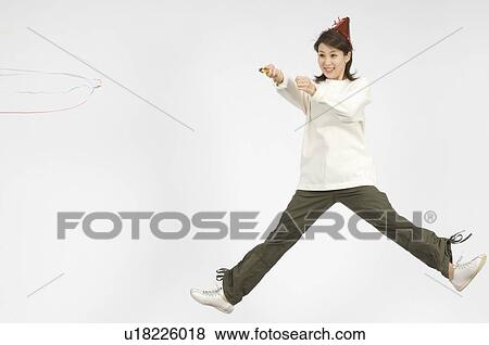Stock Photo - Young woman holding firecracker. Fotosearch