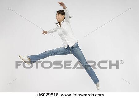 Stock Photograph - Young woman jumping. Fotosearch