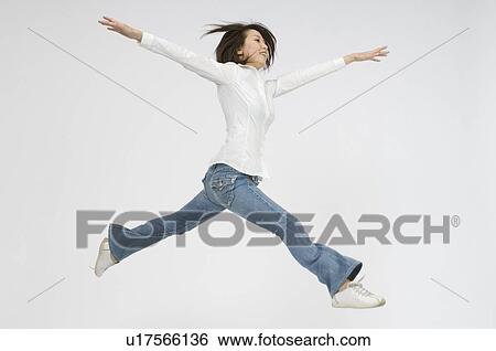 Stock Photograph - Young woman jumping. Fotosearch