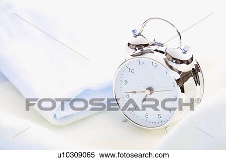 Stock Photography - Alarm clock and towel. Fotosearch