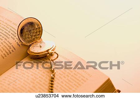 Picture - Book and pocket watch. Fotosearch