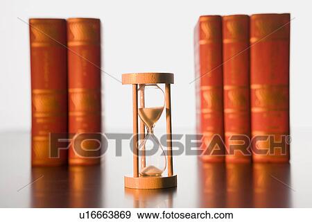 Stock Photo - Books and hourglass. Fotosearch