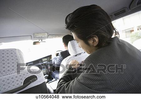 Businessman sitting in Taxi View Large Photo Image Stock Photo - Businessman sitting in Taxi. Fotosearch