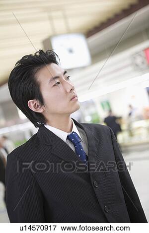 Stock Photo - Businessman standing at station. Fotosearch