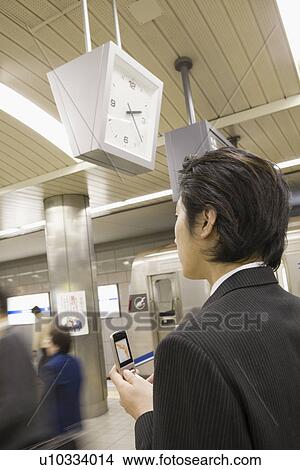 Picture - Businessman using mobile phone . Fotosearch