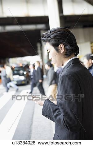 Businessman using mobile phone View Large Photo Image Stock Photograph - Businessman using mobile phone . Fotosearch