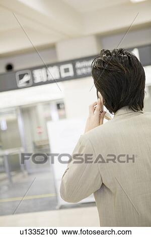 Stock Image - Businessman waiting at airport. Fotosearch