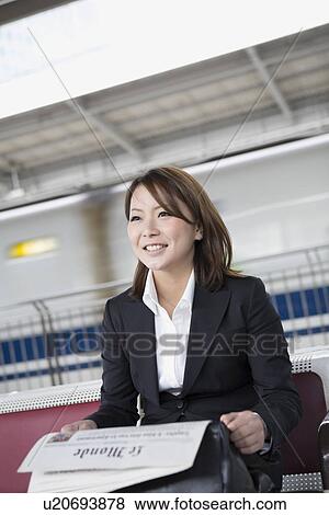 Businesswoman reading newspaper View Large Photo Image Stock Photo - Businesswoman reading newspaper. Fotosearch