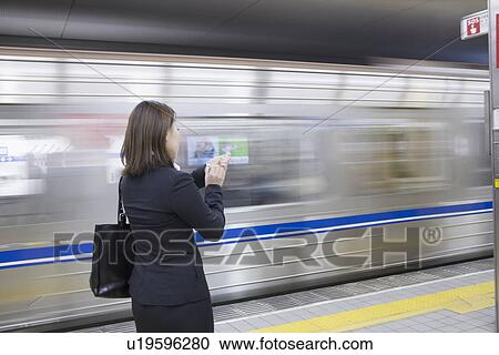 Businesswoman standing at platform View Large Photo Image Stock Image - Businesswoman standing at platform. Fotosearch