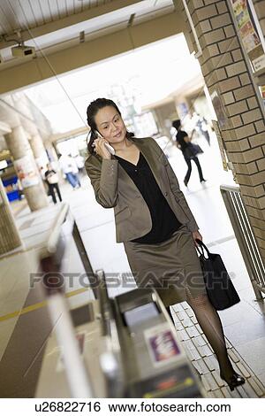 Businesswoman talking with cellular phone View Large Photo Image Stock Photograph - Businesswoman talking with cellular phone. Fotosearch