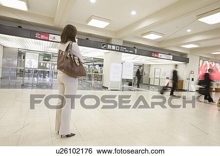 Stock Photograph - Businesswoman waiting at airport. Fotosearch
