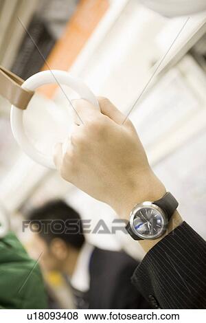 Stock Photo - Hand of businessman holding strap. Fotosearch