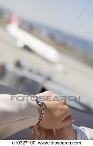 Stock Image - Hand of woman wearing wristwatch. Fotosearch